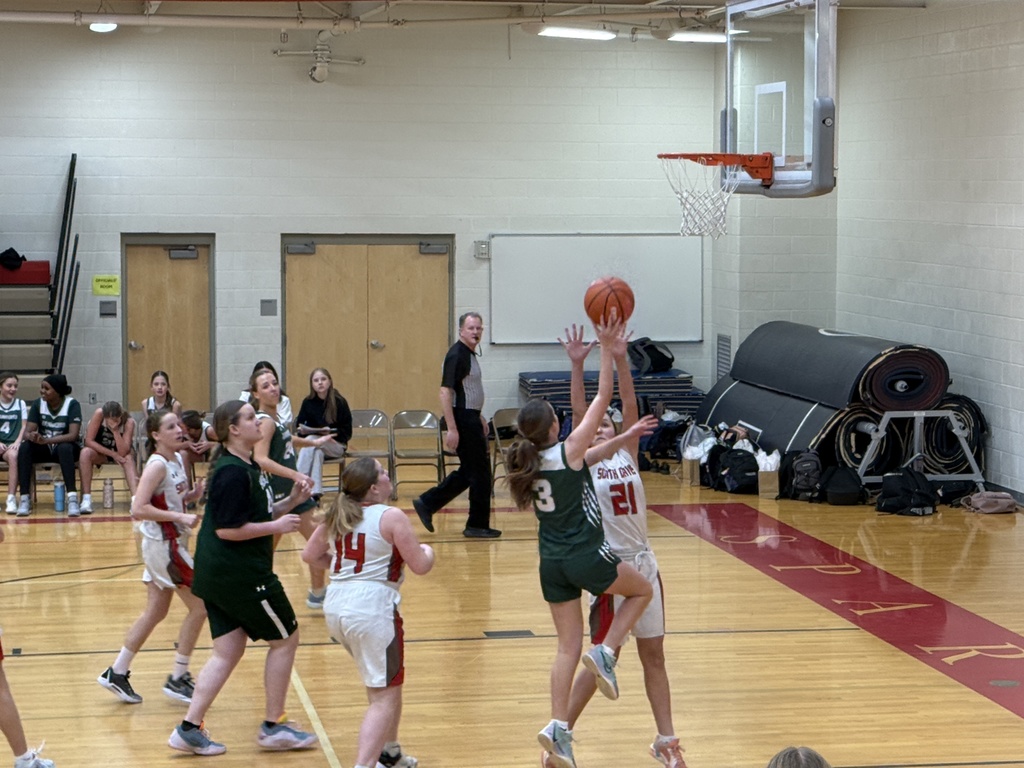 Girl shooting a basket. 