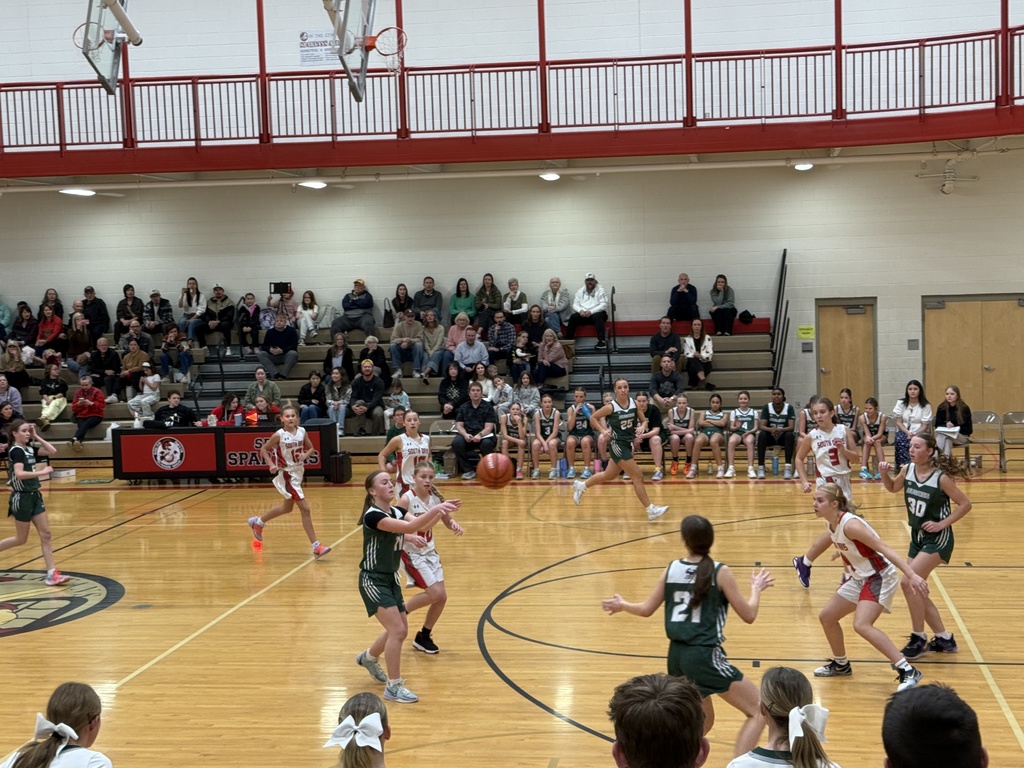 Girl passing the ball to another player. 