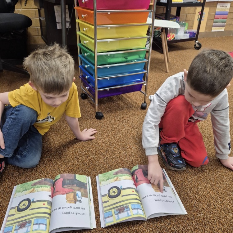 students reading a book together