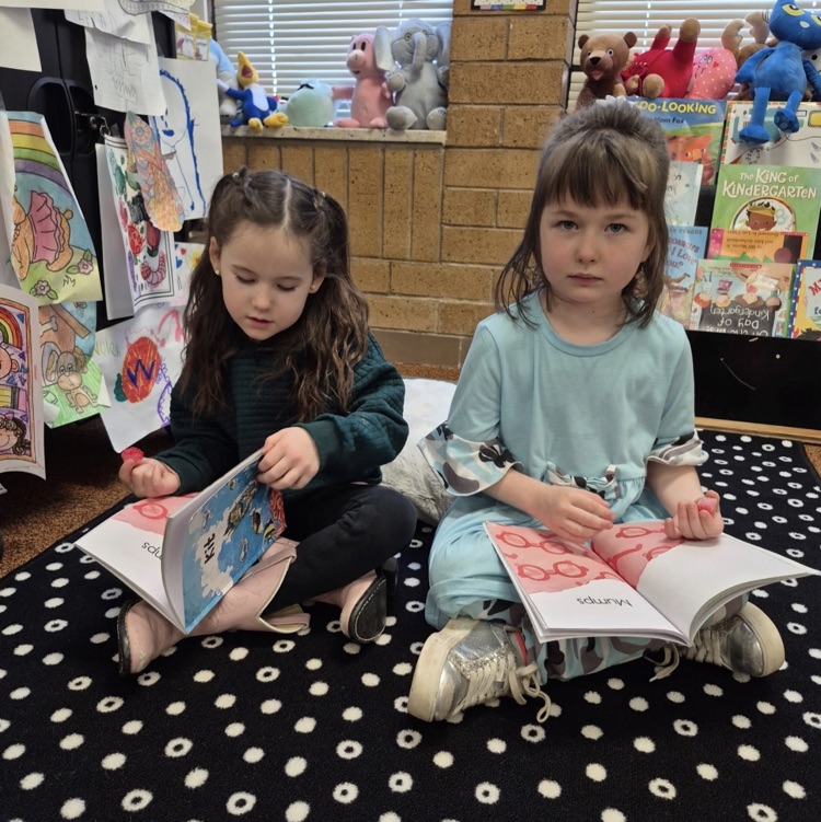 students reading a book together