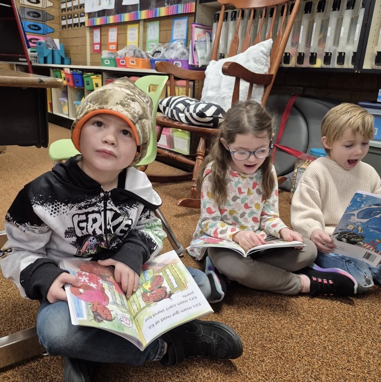 students reading a book together