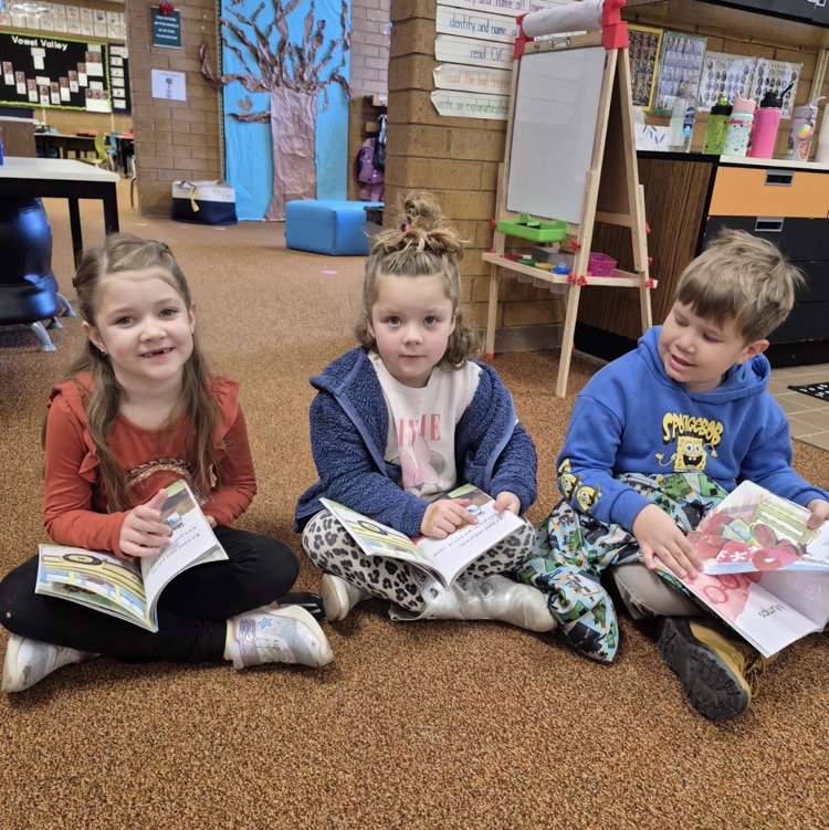 students reading a book together