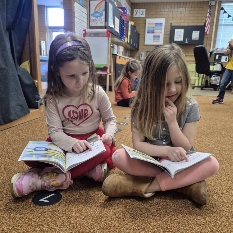 students reading a book together