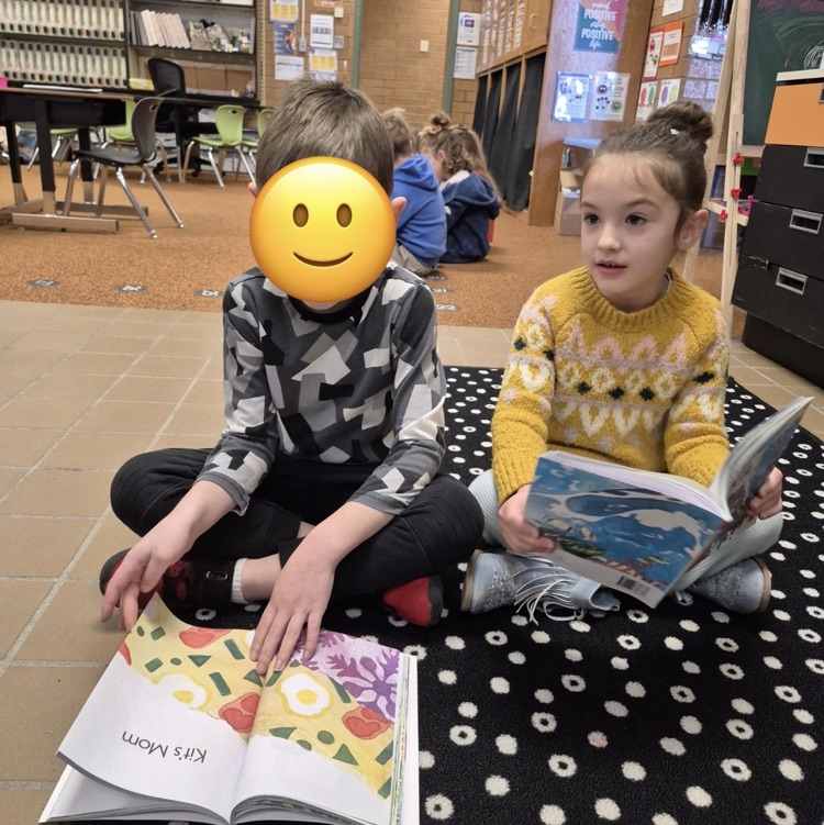 students reading a book together
