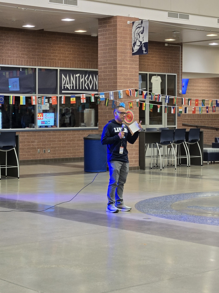 Senor Gastellum holding a mic and welcoming everyone to the dance