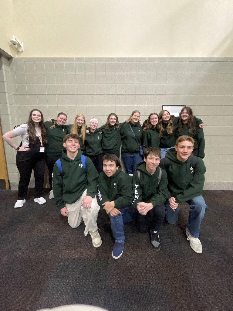 All State Choir students in sweatshirts with Mrs. Charlton.