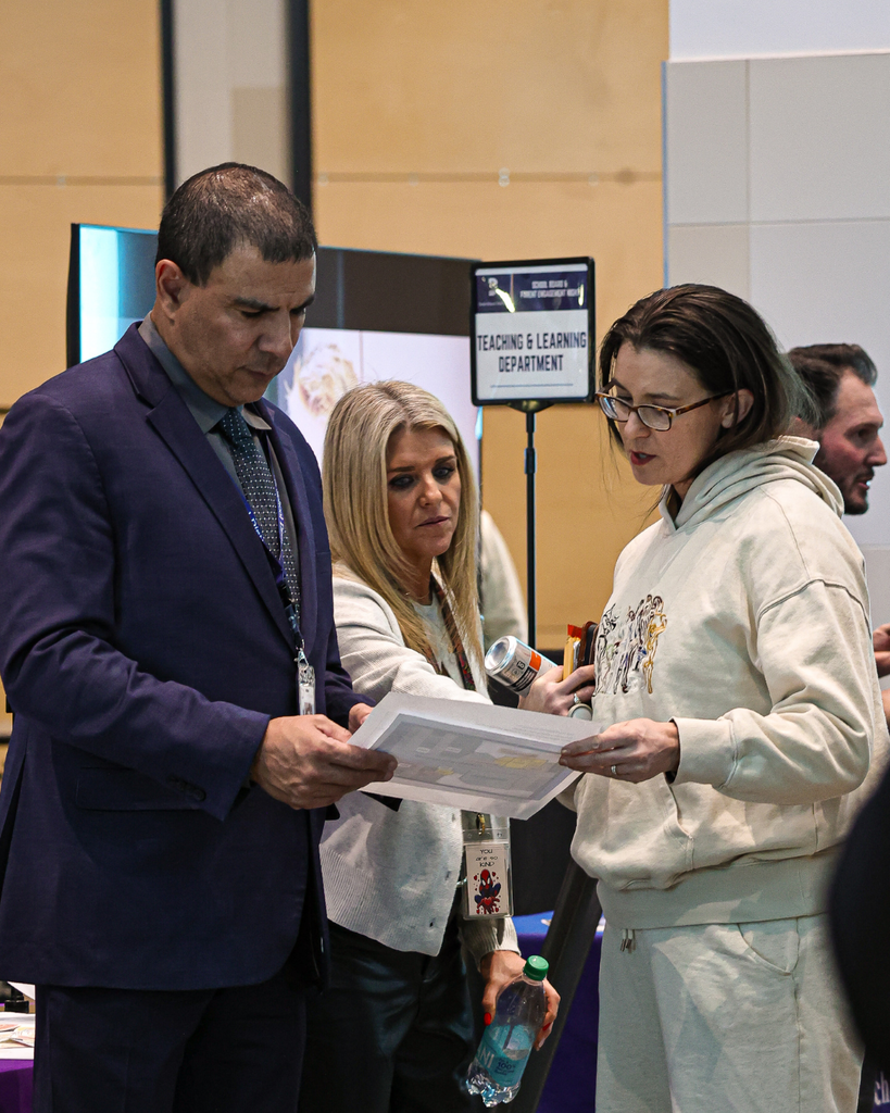 People looking at a map during the Board & Parent Engagement Night.