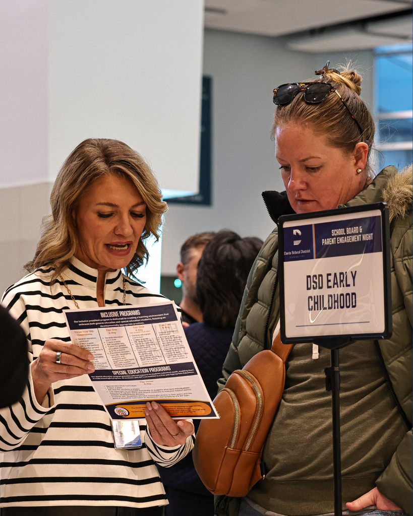People conversing at the Board & Parent Engagement Night. 