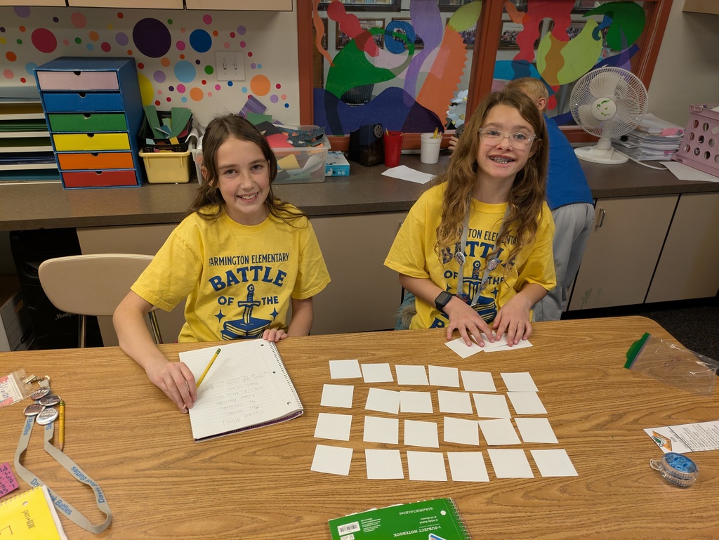 two students wearing t-shirts that read "book battle"