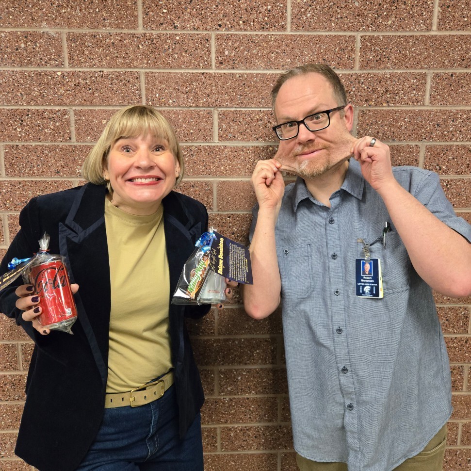 Mrs. Donaldson and Mr. Mortensen making funny faces while posing with their awards.