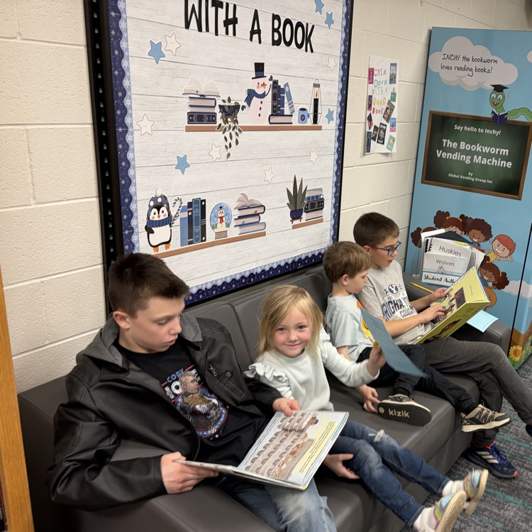 Reading buddies! 6th graders and kindergarteners are shown reading together.