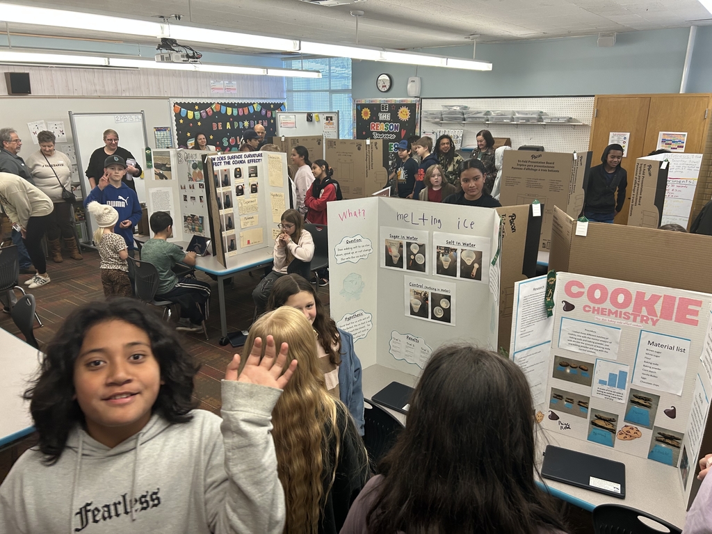 a library full of students showing off their science projects