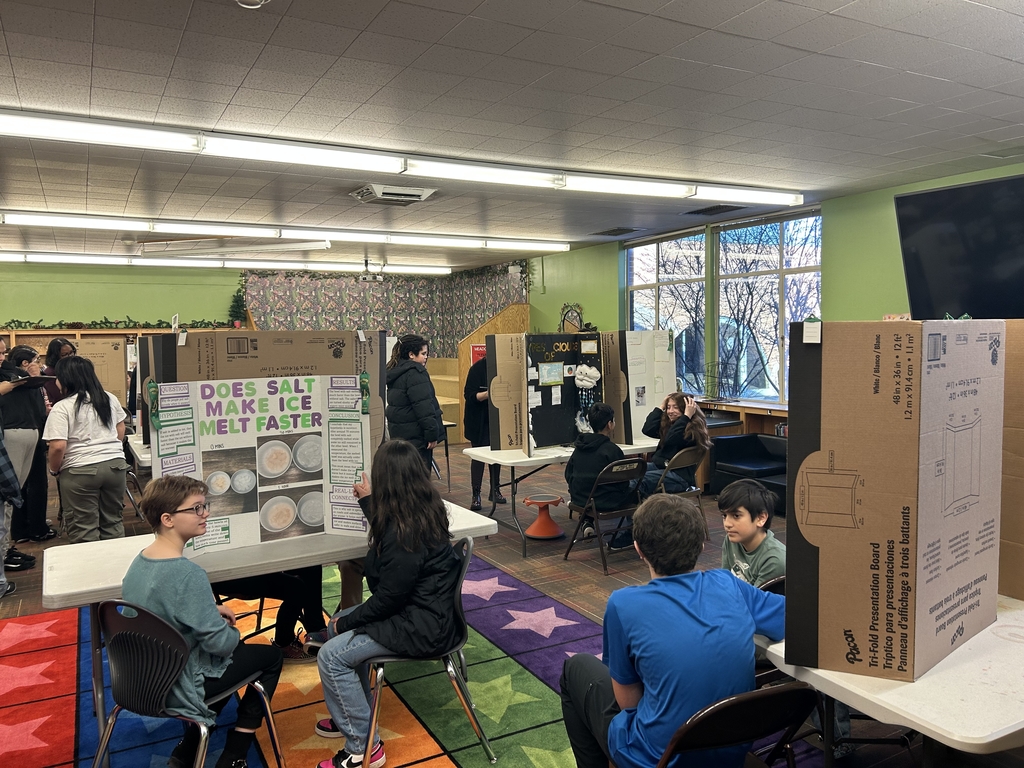 a library full of students showing off their science projects