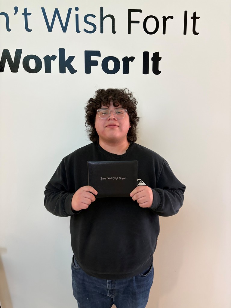 a picture of Sy Brito holding his Davis Adult high school diploma
