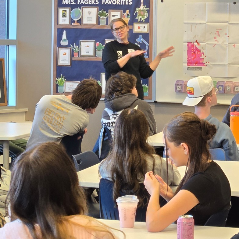 A presenter from hawkwatch teaching the class about population decline