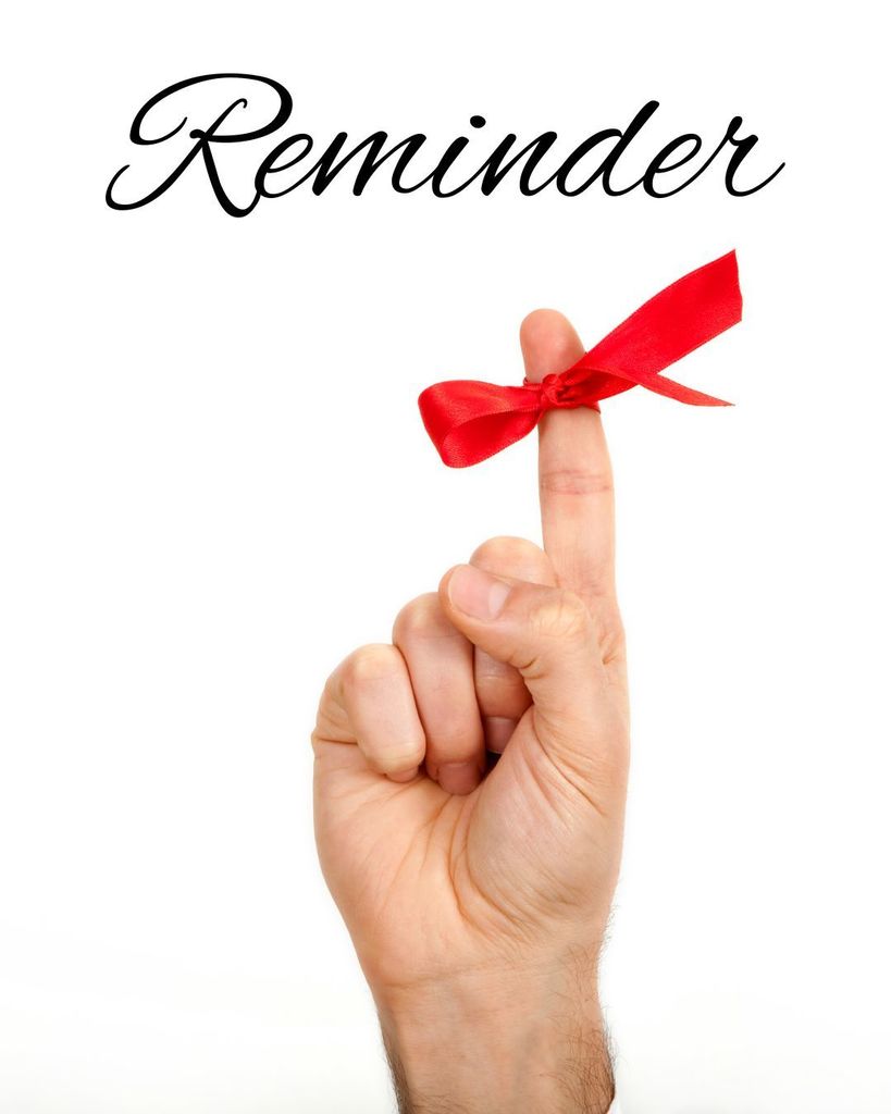 Finger with a red ribbon tied on it. Reminder