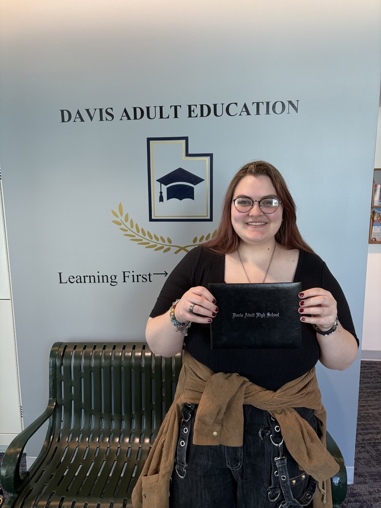 a picture of Hallie Young holding her adult high school diploma