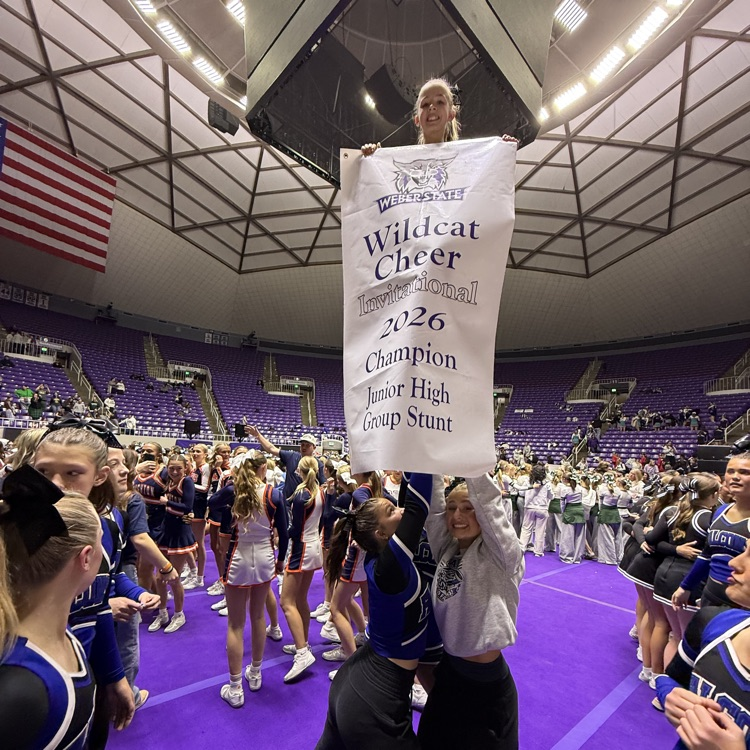 cheerleaders holding up award in a stunt pose