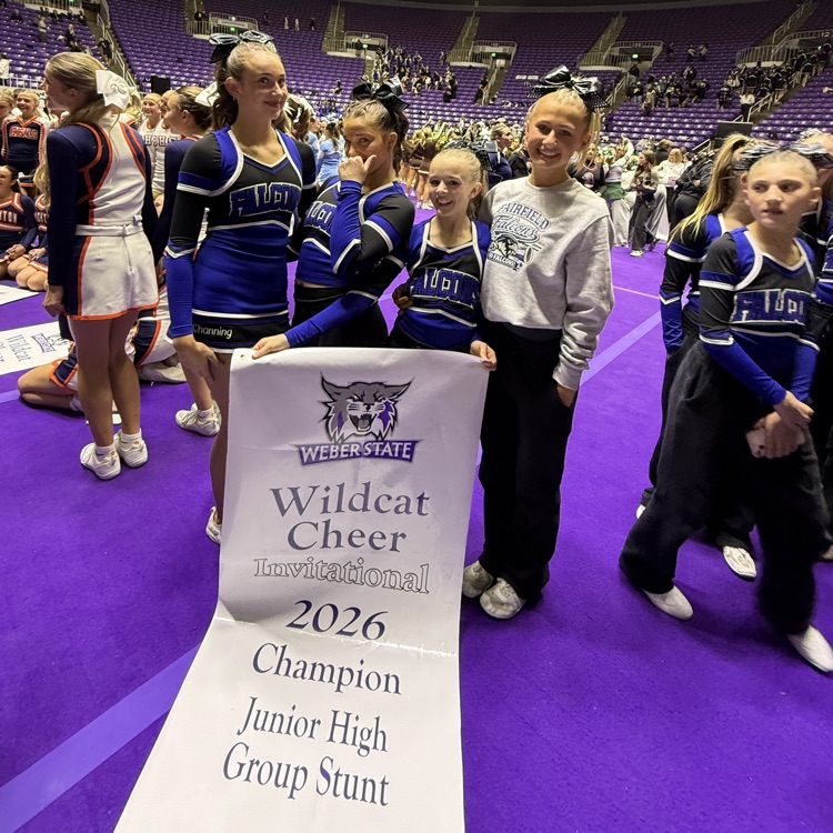 cheerleaders posing by stunt award