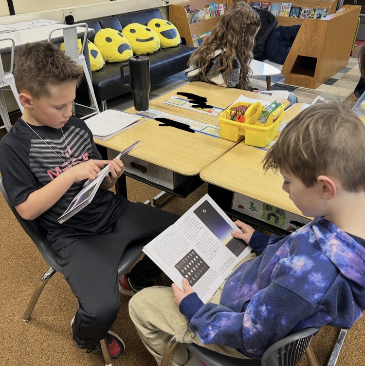 students reading about the solar system