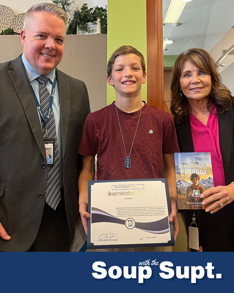A student smiling with their principal and Dr. Linford, Davis School District Superintendent. 