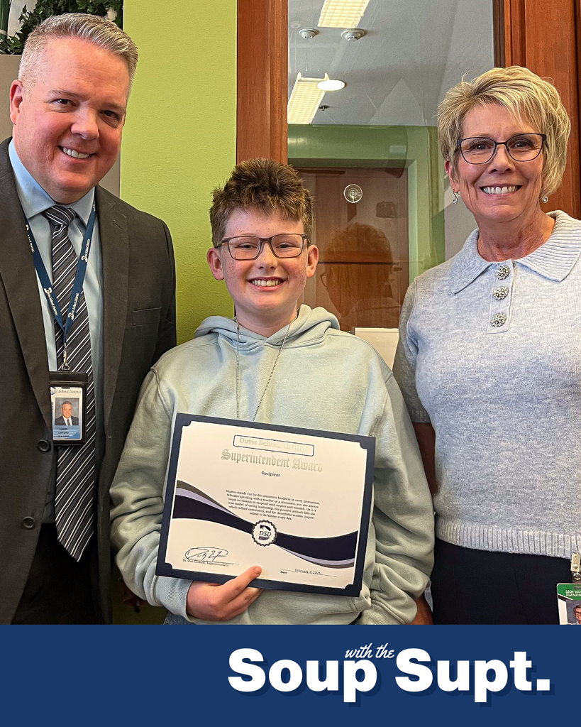 A student smiling with their principal and Dr. Linford, Davis School District Superintendent. 