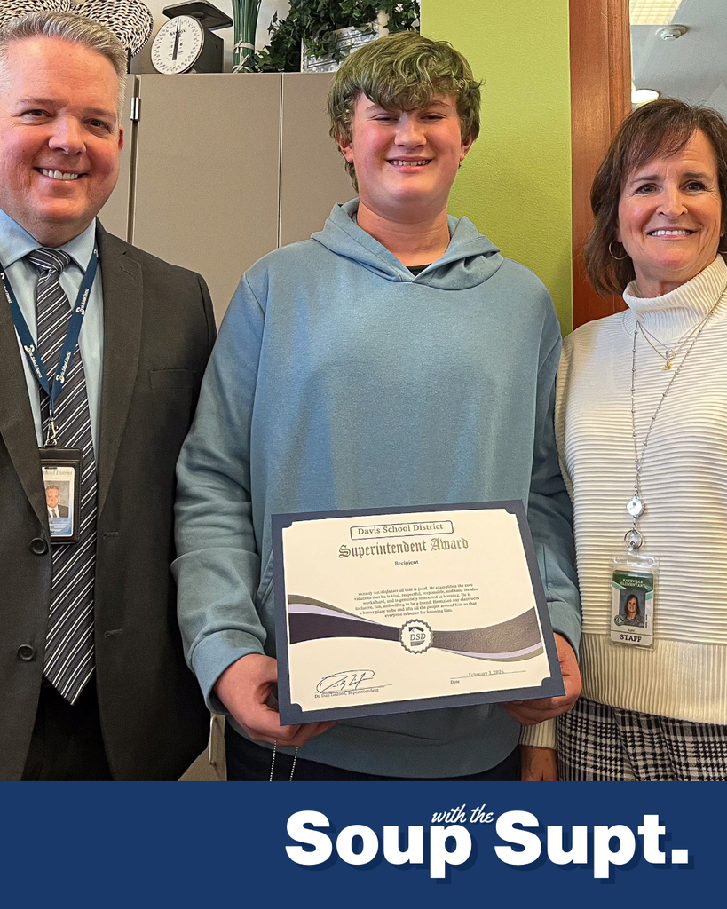 A student smiling with their principal and Dr. Linford, Davis School District Superintendent. 