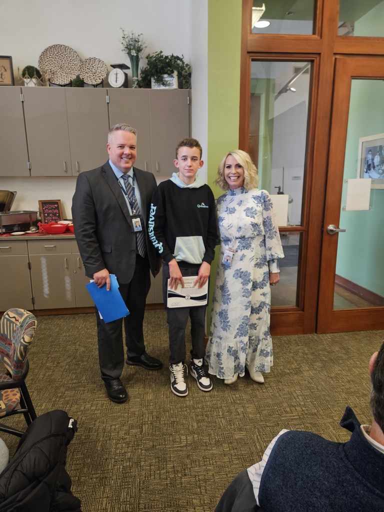 Student and Principal taking a picture with the superintendent for Soup with the  sup