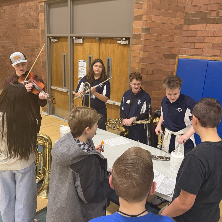 students in jazz band play their instruments for a group of incoming 7th graders
