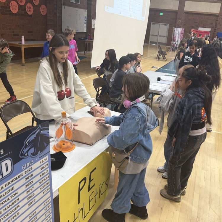 PE student representative explains to incoming 6th graders how to use do CPR with the CPR dummy