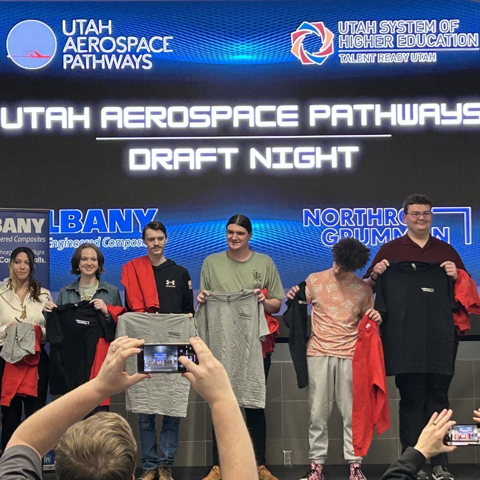 Lily and other students standing and being honored at Utah Aerospace Pathways Draft Night
