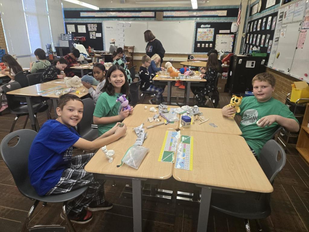4th grade students working on clay art and showing off their stuffed animals
