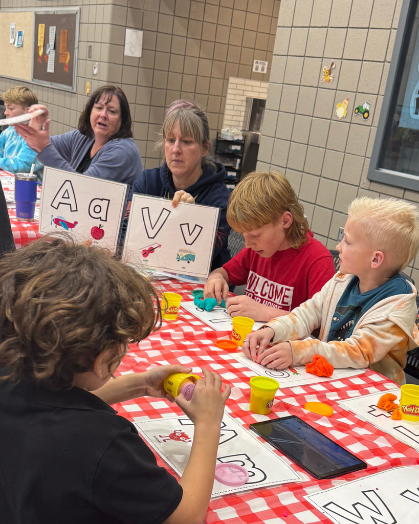 Students making letters out of play-doh. 