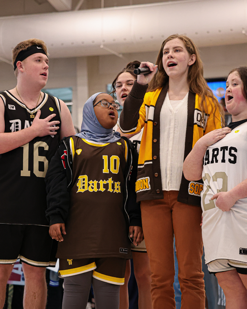 A group of Davis High students sing the national anthem at the Davis School District Unified Basketball tournament.
