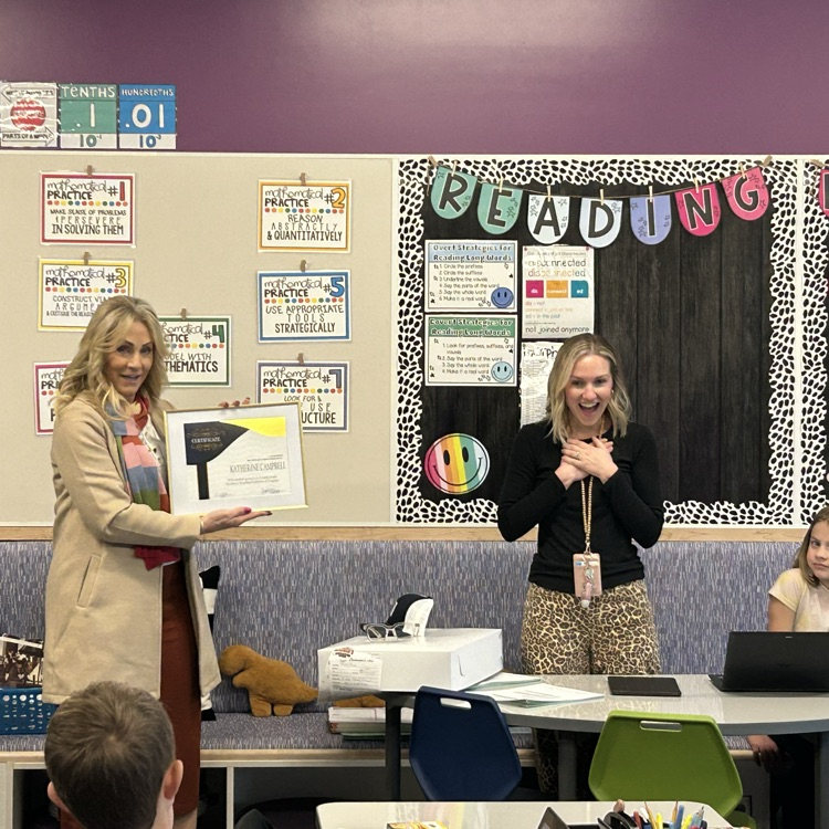 Mrs. Campbell receiving a certificate 