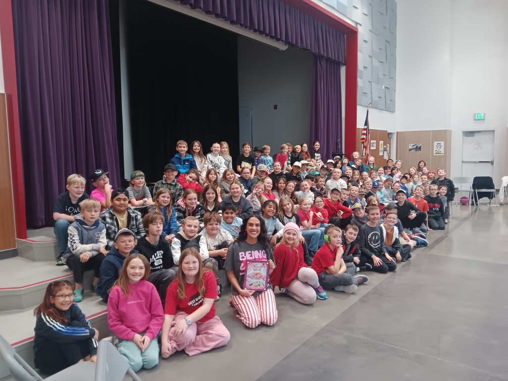 4th Grade students posing for a picture with an author.
