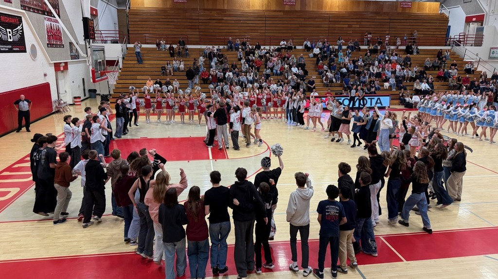 image of basketball team celebrating surrounded by crowd cheering!