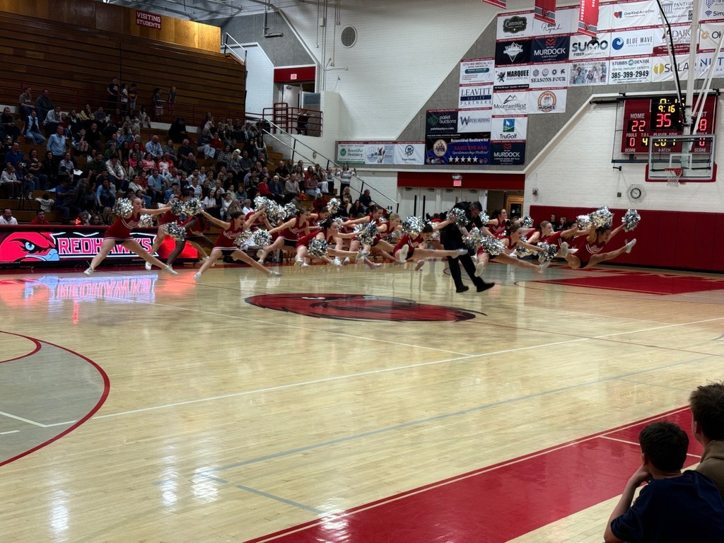 image of cheerleaders and school resource officer jumping