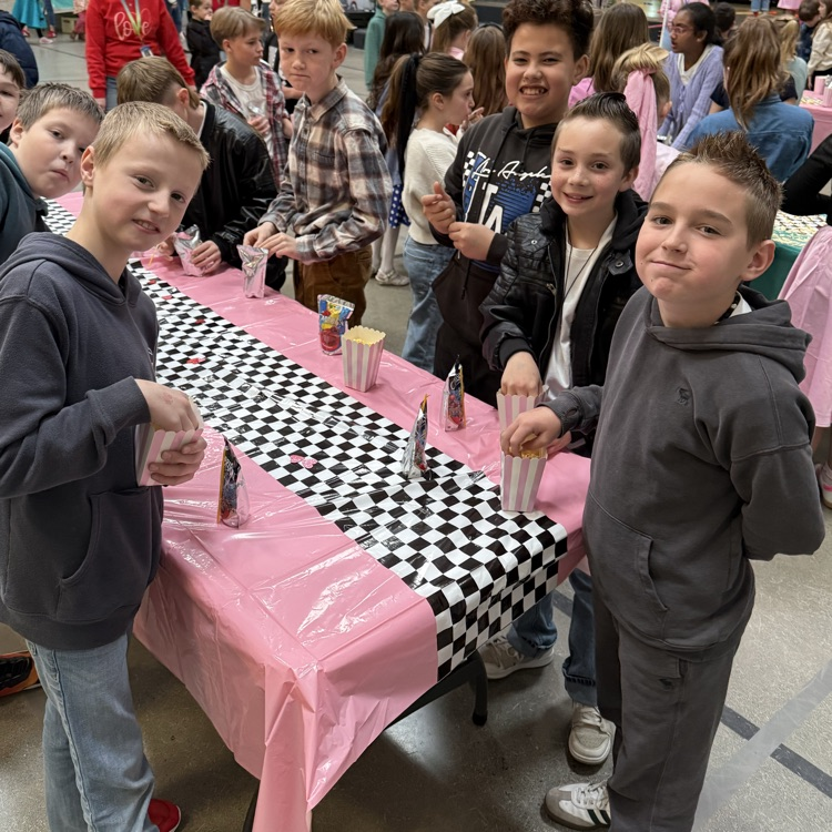 boys around a table eating popcorn
