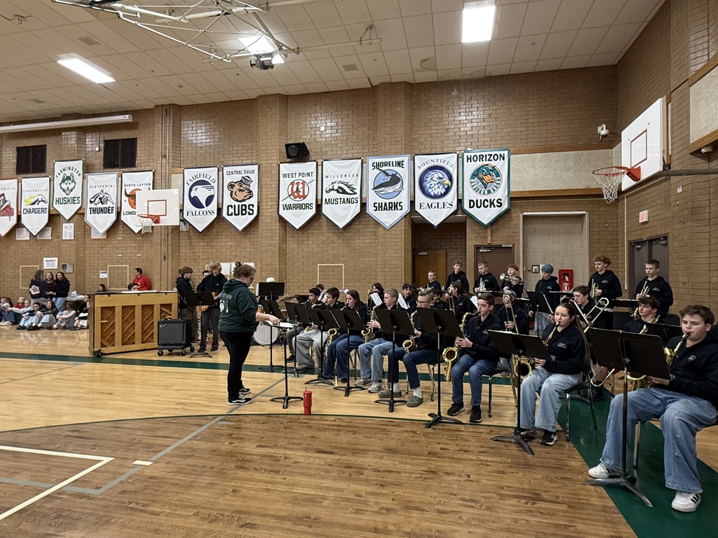 Band students playing in the assembly.