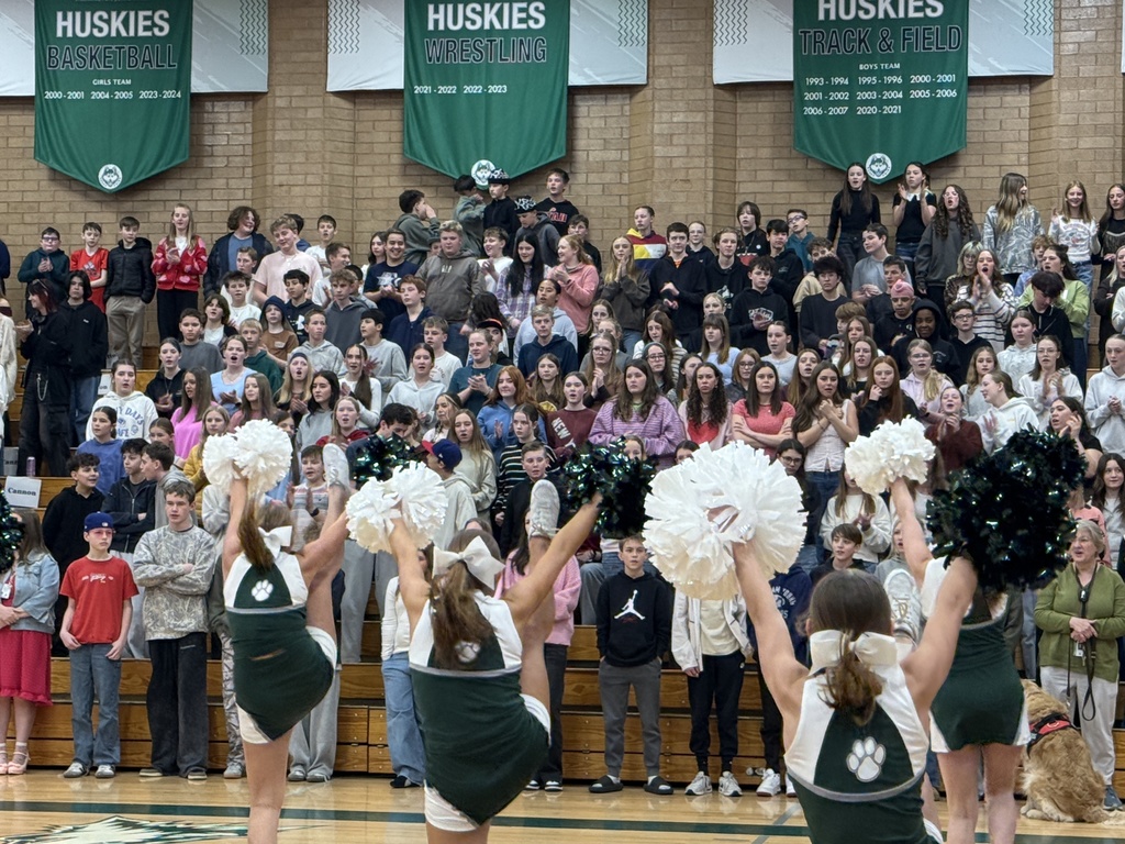 Spectators at the assembly singing the school fight song.