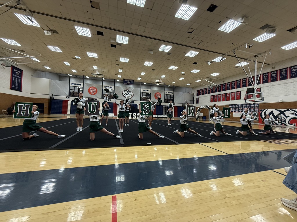 Cheerleaders spelling Huskies with signs.