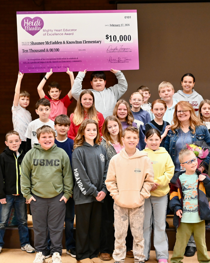 Surprise award assembly at Knowlton Elementary School where Shaunee McFadden receives the $10,000 Heidi Martin Mighty Heart Educator of Excellence Award, surrounded by students, district leaders and Foundation board members.