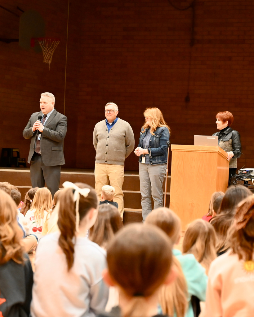 Surprise award assembly at Knowlton Elementary School where Shaunee McFadden receives the $10,000 Heidi Martin Mighty Heart Educator of Excellence Award, surrounded by students, district leaders and Foundation board members.