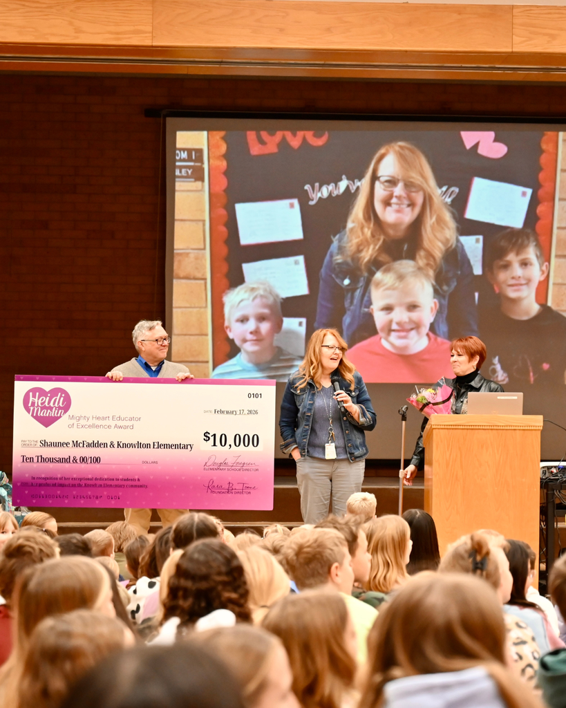 Surprise award assembly at Knowlton Elementary School where Shaunee McFadden receives the $10,000 Heidi Martin Mighty Heart Educator of Excellence Award, surrounded by students, district leaders and Foundation board members.