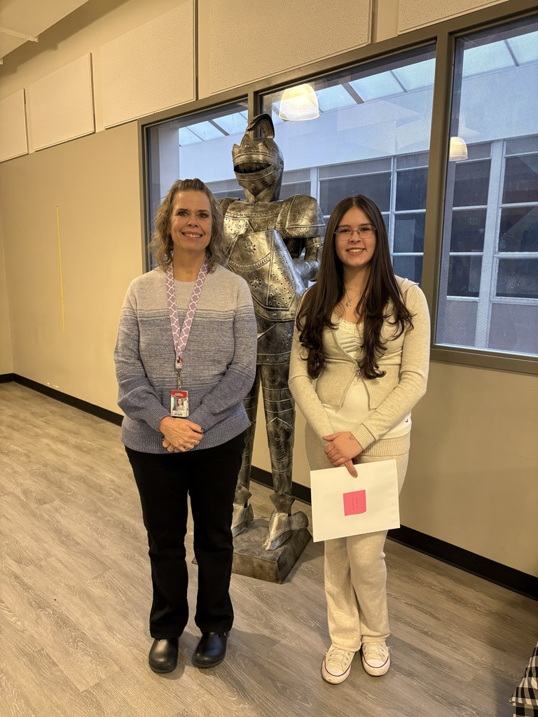 image of student and teacher standing in front of a knight statue
