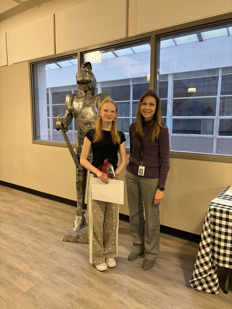 image of student and teacher standing in front of a knight statue