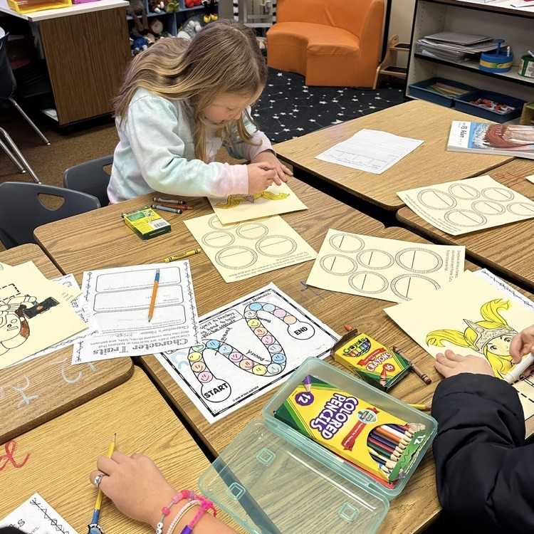 students showing their artwork to demonstrate learning from their Viking unit in CKLA Knowledge.