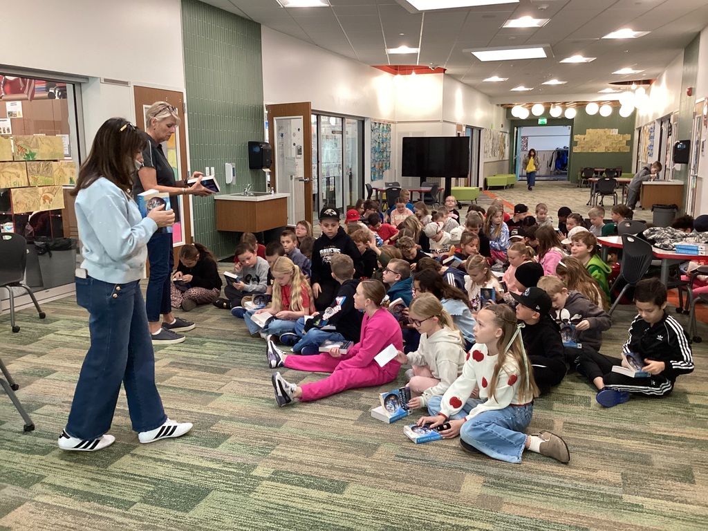 Students looking through dictionaries. 