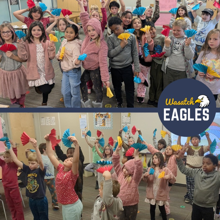 A class posing and dancing with fans.